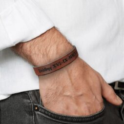 personilised leather bracelet on mans hand grey jeans white shirt