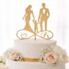Πρωτότυπο χρυσό topper τούρτας από ξύλο οκουμέ 4mm για γάμο και βάπτιση με οικογένεια πάνω στο σύμβολο του απείρου και το μονόγραμμα Κ